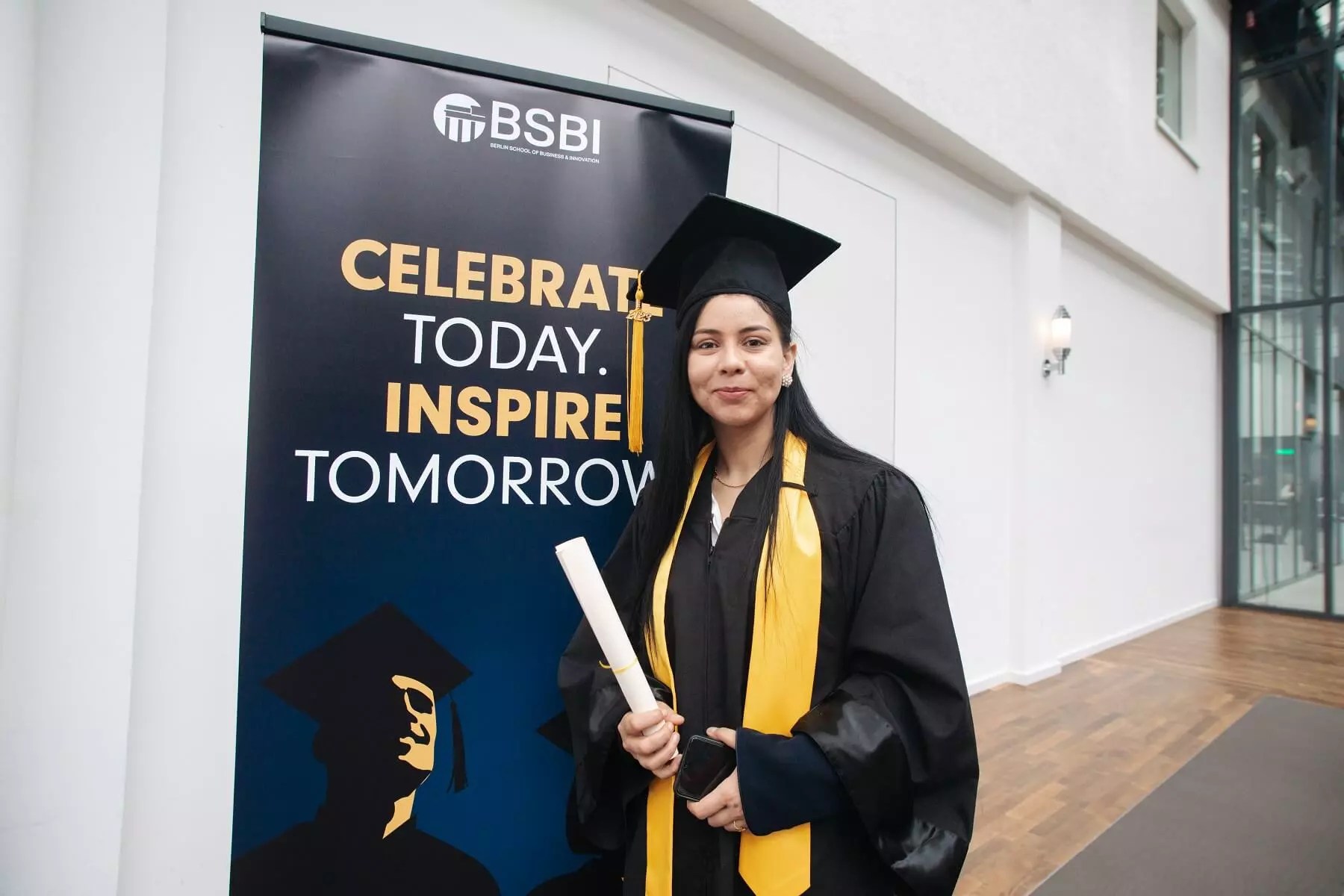 A proud BSBI graduate with her degree certificate